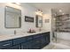 Bathroom with double sinks, quartz countertops and a stand-up shower and soaking tub at 231 2Nd S St # 201, Safety Harbor, FL 34695