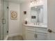 Bright bathroom features a glass shower, white vanity, and stylish decor at 231 2Nd S St # 201, Safety Harbor, FL 34695