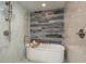 Modern bathroom showcasing sleek, marble-style walls, a soaking tub and stand-up shower at 231 2Nd S St # 201, Safety Harbor, FL 34695