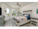 Cozy bedroom featuring a beautifully crafted bed, ample natural light, and stylish furnishings at 231 2Nd S St # 201, Safety Harbor, FL 34695
