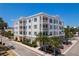 Beautiful condo building with balconies, manicured landscaping, and convenient parking spaces at 231 2Nd S St # 201, Safety Harbor, FL 34695
