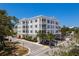 Well-maintained four-story condo building with a corner lot, lush landscaping, and ample parking spaces at 231 2Nd S St # 201, Safety Harbor, FL 34695