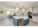 Stylish kitchen flows into the dining area featuring stainless steel appliances and island seating at 231 2Nd S St # 201, Safety Harbor, FL 34695