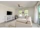 Bright living room featuring a comfortable sofa, modern furniture, and plenty of natural light from the large window at 231 2Nd S St # 201, Safety Harbor, FL 34695