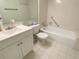 Bright bathroom featuring a vanity with white cabinets and a tiled tub-shower combination at 2643 Pine Ridge S Way # A1, Palm Harbor, FL 34684