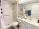 Bathroom with shower and sink; with tile flooring and walls; natural light at 2643 Pine Ridge S Way # A1, Palm Harbor, FL 34684
