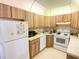Bright kitchen with white appliances, ample cabinetry, and well-lit countertops at 2643 Pine Ridge S Way # A1, Palm Harbor, FL 34684