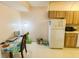 Functional kitchen area featuring white appliances, ample storage, and neutral tile flooring at 2643 Pine Ridge S Way # A1, Palm Harbor, FL 34684
