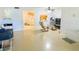 Spacious living area with tile flooring seamlessly flowing into the kitchen area at 2643 Pine Ridge S Way # A1, Palm Harbor, FL 34684