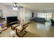 Open-concept living room with tile floors, ceiling fan, and access to the outdoors at 2643 Pine Ridge S Way # A1, Palm Harbor, FL 34684
