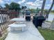 Community pool grilling area with grill, covered grill, and a table, perfect for outdoor meals and gatherings at 2643 Pine Ridge S Way # A1, Palm Harbor, FL 34684