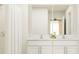 Bathroom with a double vanity, a large mirror, and elegant fixtures at 2726 Bryce Ravine Ave, Plant City, FL 33563
