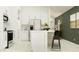 Modern kitchen featuring white cabinets, stainless steel appliances, and a functional center island at 2726 Bryce Ravine Ave, Plant City, FL 33563