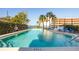 Relaxing community pool with lounge chairs and tropical landscaping with ocean views at 30 Turner St # 802, Clearwater, FL 33756