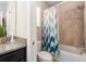 Neutral bathroom featuring a shower-tub combo with a stylish chevron shower curtain at 311 Vista Cruiser Ln, Oldsmar, FL 34677