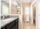 Well-lit bathroom features dark cabinets, a granite countertop, and a glass-enclosed shower at 311 Vista Cruiser Ln, Oldsmar, FL 34677