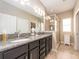 Stylish bathroom with granite countertops, dual sinks, and a modern glass enclosed shower at 311 Vista Cruiser Ln, Oldsmar, FL 34677