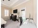 Bedroom with an abundance of natural light, featuring a dedicated workspace and outdoor access at 311 Vista Cruiser Ln, Oldsmar, FL 34677