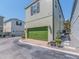 Townhome features a bright green garage door and easy landscaping at 311 Vista Cruiser Ln, Oldsmar, FL 34677