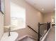 Upstairs hallway features carpet, neutral paint, a window for natural light and staircase at 311 Vista Cruiser Ln, Oldsmar, FL 34677