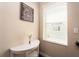 Upstairs hallway features a decorative print, white accent table, and a window overlooking the neighborhood at 311 Vista Cruiser Ln, Oldsmar, FL 34677
