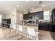 A kitchen features dark cabinets, stainless steel appliances, granite countertops and an island with seating at 311 Vista Cruiser Ln, Oldsmar, FL 34677