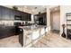 Modern kitchen with dark cabinetry, granite countertops, stainless steel appliances, and a breakfast bar at 311 Vista Cruiser Ln, Oldsmar, FL 34677