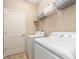 The laundry room is equipped with modern appliances and ample storage shelving at 311 Vista Cruiser Ln, Oldsmar, FL 34677