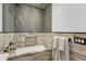 Elegant bathroom featuring a soaking tub with granite surround and a glass-enclosed shower at 3111 W De Leon St # 8, Tampa, FL 33609
