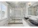 Luxurious bathroom with marble and glass enclosed shower with dual shower heads, and vessel sinks at 3111 W De Leon St # 8, Tampa, FL 33609