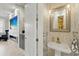 Chic bathroom featuring marble tiling, a pedestal sink, and a decorative mirror at 3111 W De Leon St # 8, Tampa, FL 33609