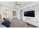 Cozy bedroom featuring integrated media center, modern ceiling fan and an ensuite bath and walk-in closet at 3111 W De Leon St # 8, Tampa, FL 33609