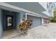 Stylish townhouse showing the garage door, front door, and brick paver driveway at 3111 W De Leon St # 8, Tampa, FL 33609