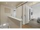 Upstairs hallway with barn doors, leading to bedroom with custom closet and ensuite bath at 3111 W De Leon St # 8, Tampa, FL 33609