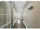 Hallway featuring a gray floor, a coat rack, recessed lighting, and staircase leading to a window at 3111 W De Leon St # 8, Tampa, FL 33609