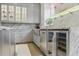 Stylish kitchen with stainless steel fridge and wine cooler, complemented by gray cabinets and granite countertops at 3111 W De Leon St # 8, Tampa, FL 33609