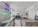 Open kitchen flows into dining area, featuring granite counters, stainless steel appliances, and modern lighting at 3111 W De Leon St # 8, Tampa, FL 33609
