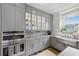 Modern kitchen with stainless steel appliances, gray cabinets and marble countertops at 3111 W De Leon St # 8, Tampa, FL 33609