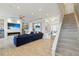 Bright living room with modern fireplace, large TV, and an inviting blue sofa at 3111 W De Leon St # 8, Tampa, FL 33609