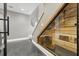 Basement stairwell adjacent to a custom wine cellar with a glass front at 3111 W De Leon St # 8, Tampa, FL 33609