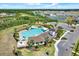 Aerial view of community clubhouse, pool, playground, parking and other amenities at 33030 Major Oak Dr, Wesley Chapel, FL 33545