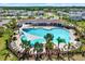 Aerial view of a community pool area with lounge chairs, umbrellas, and palm trees at 33030 Major Oak Dr, Wesley Chapel, FL 33545