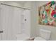 Bathroom features a shower and toilet with colorful art at 33030 Major Oak Dr, Wesley Chapel, FL 33545