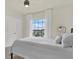 Neutral bedroom with a window and ceiling fan at 33030 Major Oak Dr, Wesley Chapel, FL 33545