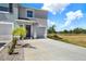 Inviting two-story home featuring a well-manicured lawn and a spacious driveway at 33030 Major Oak Dr, Wesley Chapel, FL 33545