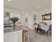 Open kitchen and dining area with granite countertops, island seating, and a view to the adjacent table at 33030 Major Oak Dr, Wesley Chapel, FL 33545