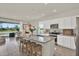 Bright kitchen featuring granite countertops, modern appliances, an island with bar seating, and a view of the backyard at 33030 Major Oak Dr, Wesley Chapel, FL 33545