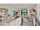 Open kitchen with a granite island, stainless steel appliances, and an adjacent living area at 33030 Major Oak Dr, Wesley Chapel, FL 33545
