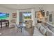 Cozy living room with neutral furniture, a mounted TV, and a sliding glass door leading to the patio at 33030 Major Oak Dr, Wesley Chapel, FL 33545