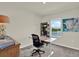 Office features an adjustable desk, shelves and a water view at 33030 Major Oak Dr, Wesley Chapel, FL 33545